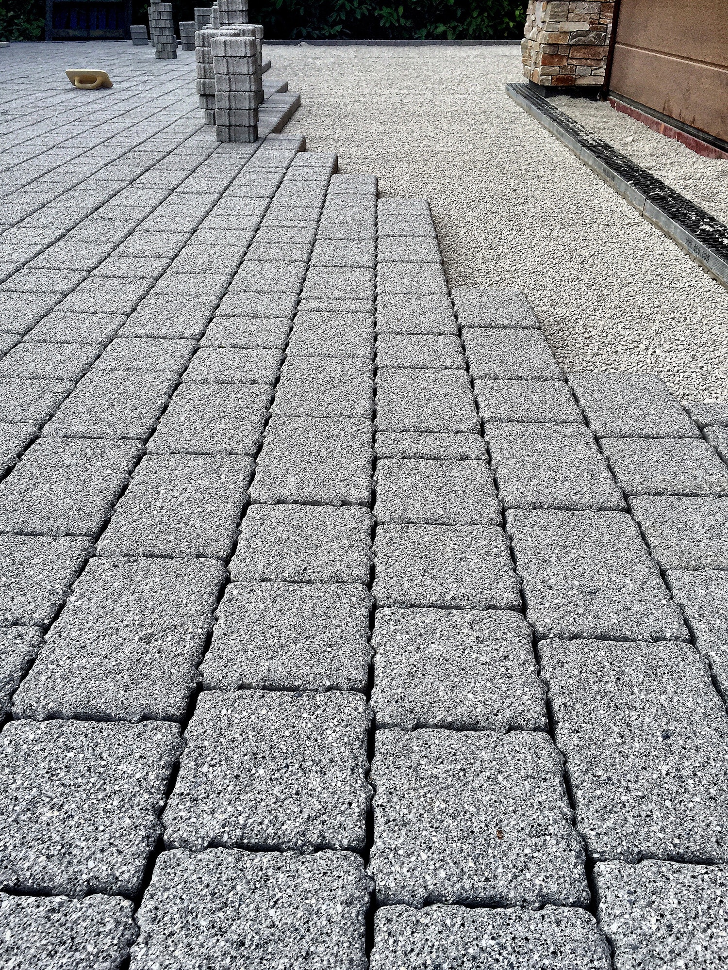 Paving blocks being laid on a driveway.